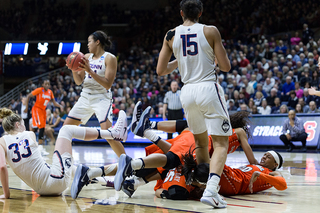 Syracuse players fall over each other going for a loose ball. Connecticut, meanwhile, starts transition.