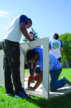 Juniors Josue Luna, an IT major (right), and Wilfredo Castillo, an international relations major (left), work on building the Lambda Upsilon Lambda shack on the quad.