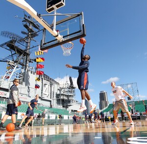 Rakeem Christmas dunks the ball during practice on the USS Midway Saturday. The players had to deal with windy conditions that affected their shots throughout the day.