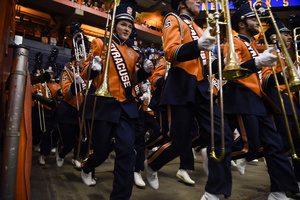 The SU marching band files onto the field for game day.