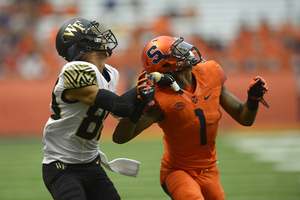 Cornerback Julian Whigham looks up with a Wake Forest receiver as the ball approaches. 