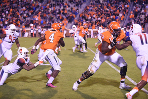 Virginia tailback Taquan Mizzell (4) avoids several Syracuse defenders. He helped UVA beat the Orange with 69 receiving yards and 58 rushing yards.