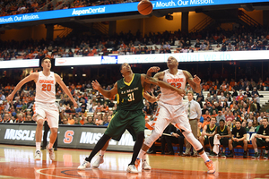 DaJuan Coleman (32) looks up at the ball as Tyler Lydon (20) watches from afar.