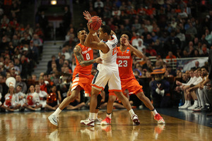 Michael Gbinije and Malachi Richardson swarm Virginia's Malcom Brogdon in accordance to the team's late switch to a press defense.