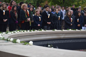 Remembrance Scholars stand behind the Wall of Remembrance thats honors the 270 people that died in Pan Am Flight 103. 