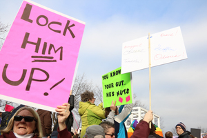 A woman holds a sign in the Syracuse sister march that reads 