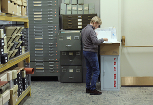 One of the Onondaga Historical Association's volunteers search through files in their research center.