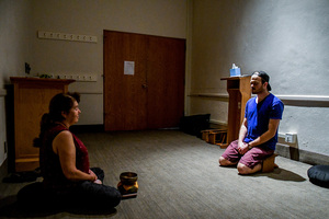 Joanne Cooke (left) and Andrew Maloney (right) sit in the small chapel in the basement of Hendricks Chapel for a meditation session.