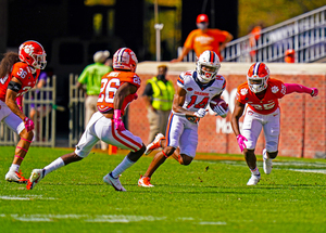 Redshirt sophomore Anthony Queeley dodges Clemson defenders after a reception. 