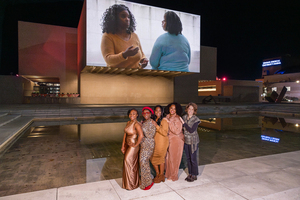 The people in Lynne Sachs’ film “This Side of Salina” pose in front of the Everson Museum of Art’s projection of it. The film is part of Light Work’s Urban Video Project.
