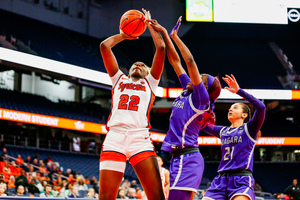 Syracuse forward Kyra Wood (pictured, No. 22) hauls in one of her team-best eight rebounds against Niagara.