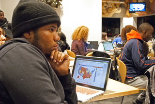 Jonathan Faust, a senior computer engineering major, follows the election live online while attending the College Republicans Celebration in the Schine dining room.