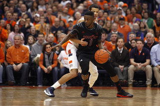 Syracuse point guard Michael Carter-Williams guards Cincinnati guard Cashmere Wright during the second half.