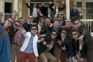 Fraternity brothers gather on Walnut Place to join in celebrations of sorority bid day. 