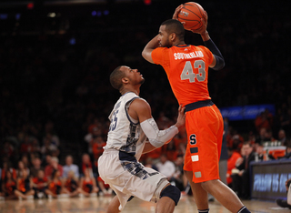 James Southerland towers over Georgetown's Jabril Trawick (#55), looking for an open teammate.