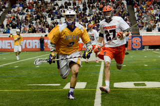 Sean Young and an Albany midfielder chase down a ball.