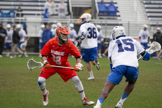 Syracuse defender Tom Grimm keeps up with Duke midfielder Myles Jones. Jones scored five goals in the contest. 