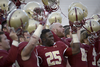 The Eagles raise their helmets to the crowd after their seventh win of the season.