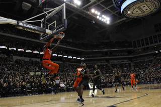 Rakeem Christmas hangs on the rim after throwing down a two-handed dunk. The senior played all 40 minutes and totaled 23 points.