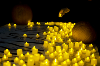 A student places a candle on top of the 