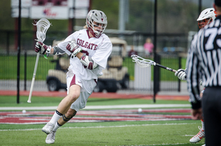 A Colgate player works around the cage. 