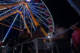 The line for one of the New York State Fair's Ferris wheels blurs as fairgoers load onto the gondolas.