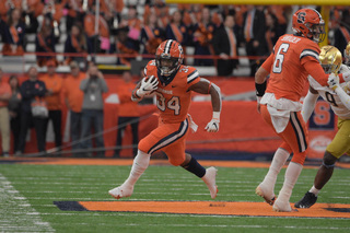 Sean Tucker takes off down the field hoping to score a touchdown for the Orange. The running back weaved his way through the players and found a spot to make a breakaway. 